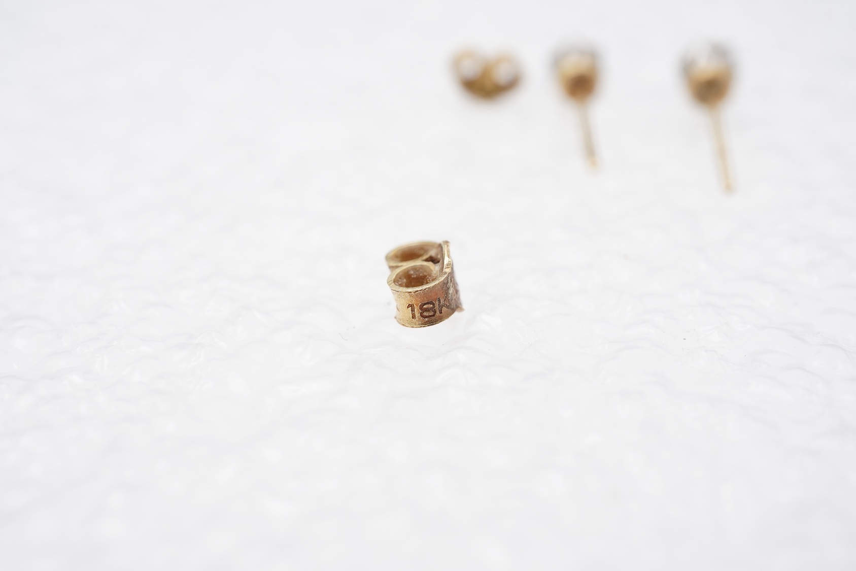 A pair of diamond stud earrings